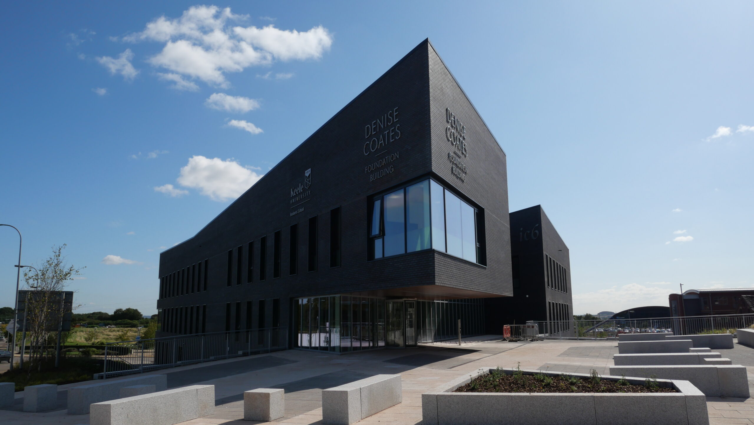 Keele University’s Smart Innovation Hub, a modern, angular building with dark brickwork and large windows.
